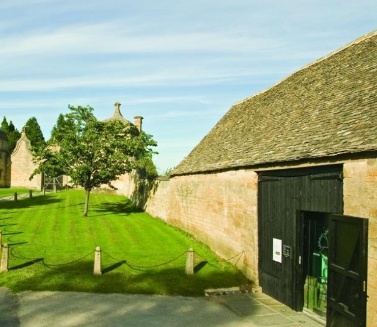 Outside view of Cotswold stone barn housing museum. Family-friendly activities